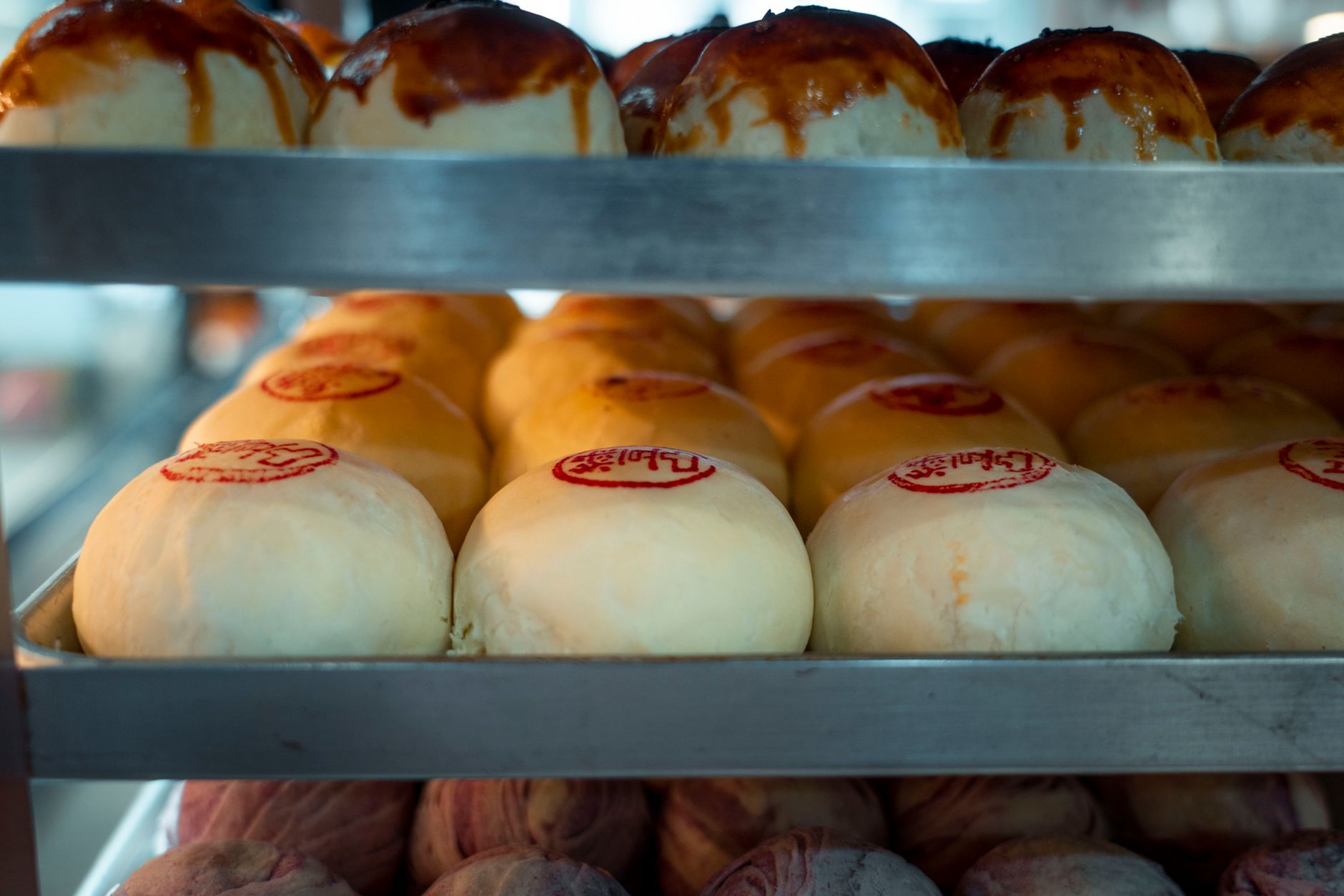 Close-up photo of traditional stamped mooncakes on a bakery rack in Taipei, Taiwan.