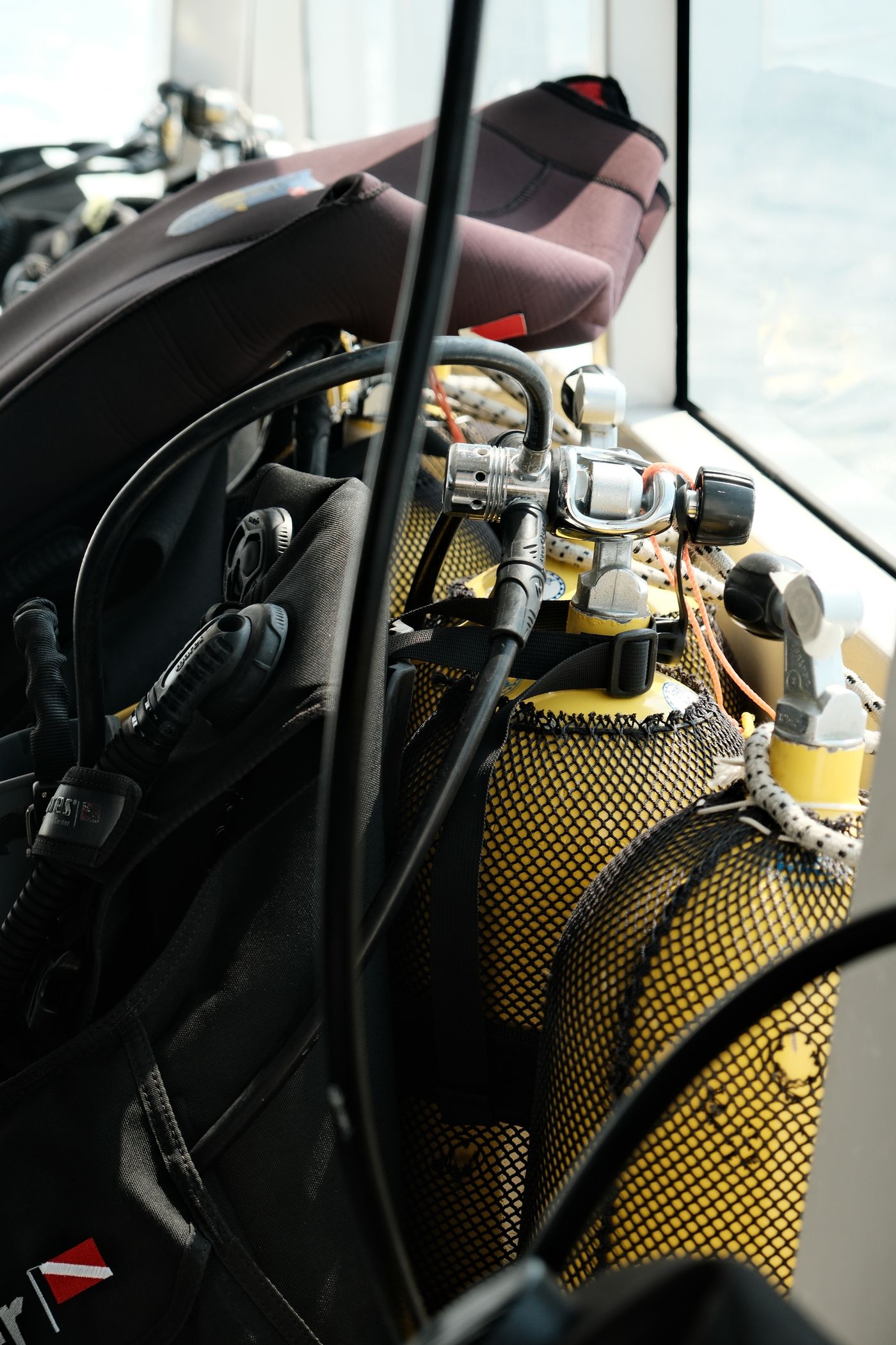 Scuba tanks and dive gear staged on the deck of a boat, ready for a dive.