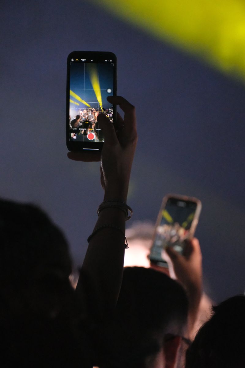 Music fans recording a live concert with smartphones