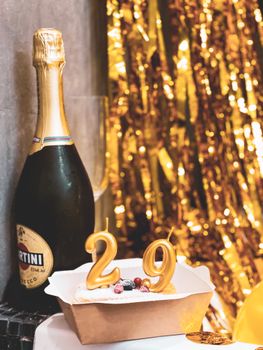 Luxurious birthday setup with champagne, cake, and festive decorations.