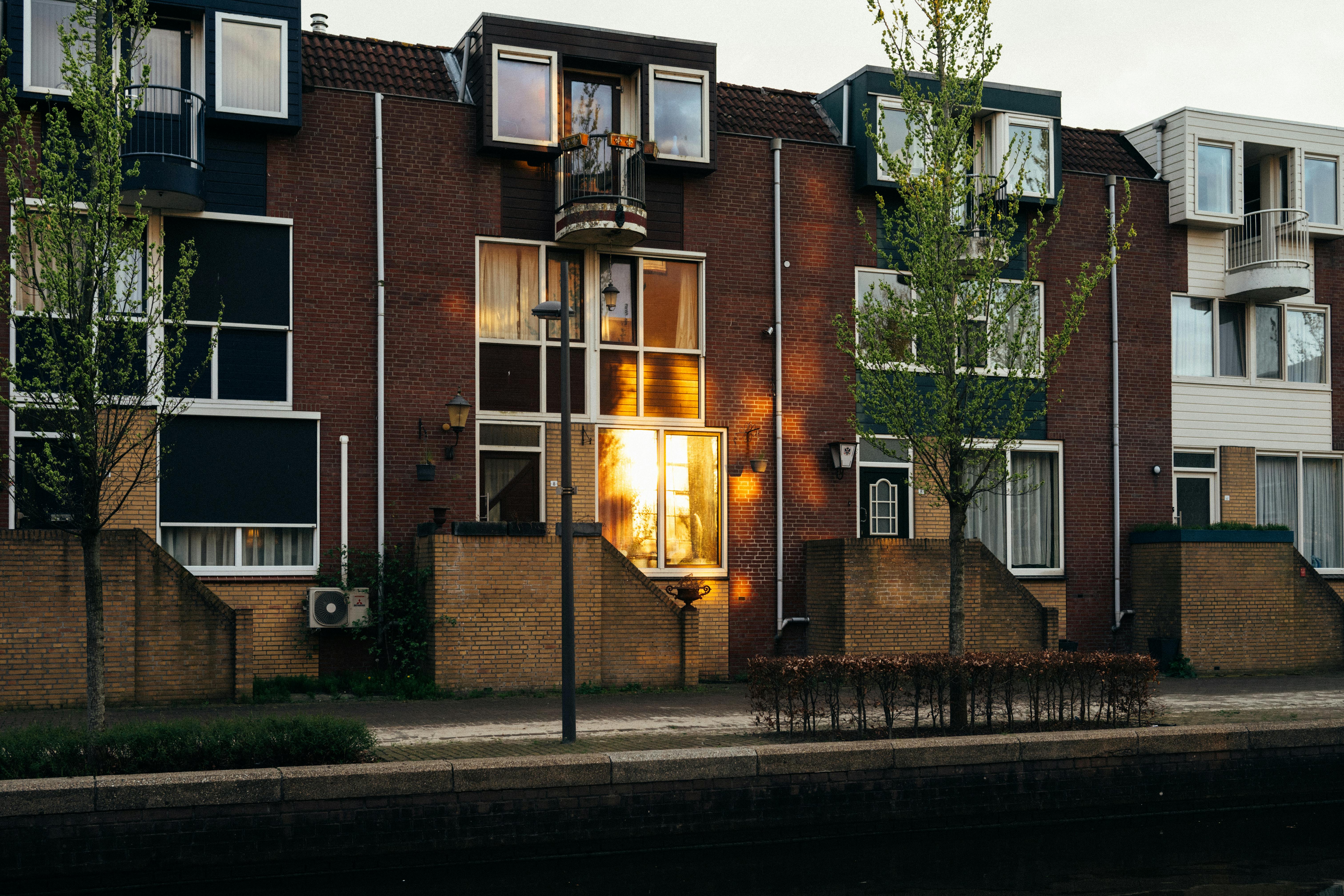 Charming sunset reflection on modern Dutch townhouses in Almere, Netherlands.
