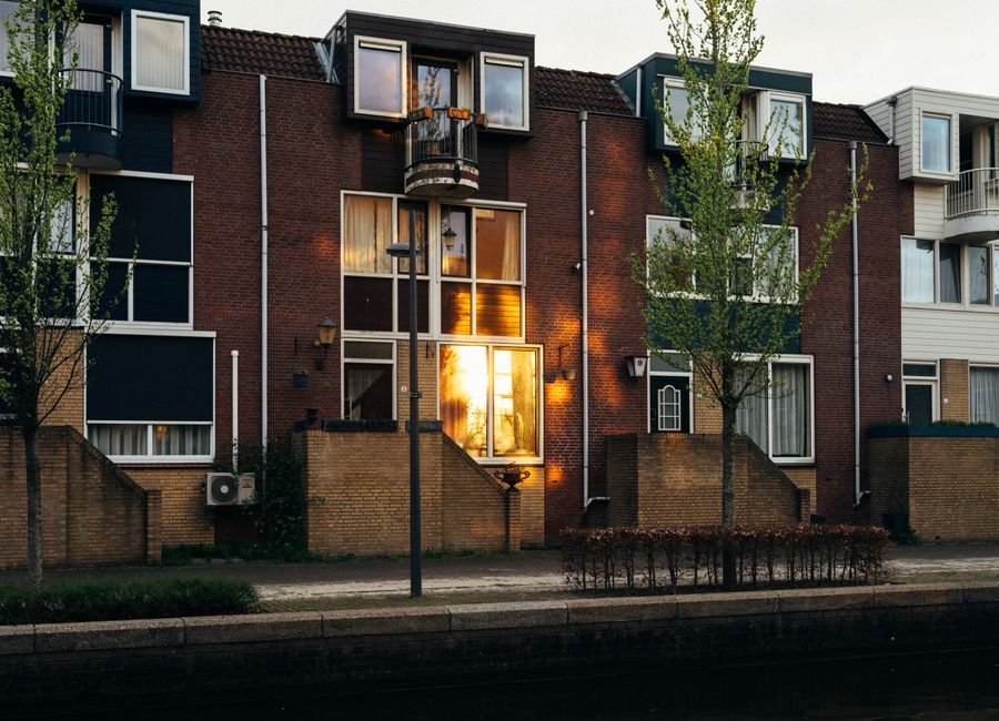 Charming sunset reflection on modern Dutch townhouses in Almere, Netherlands.