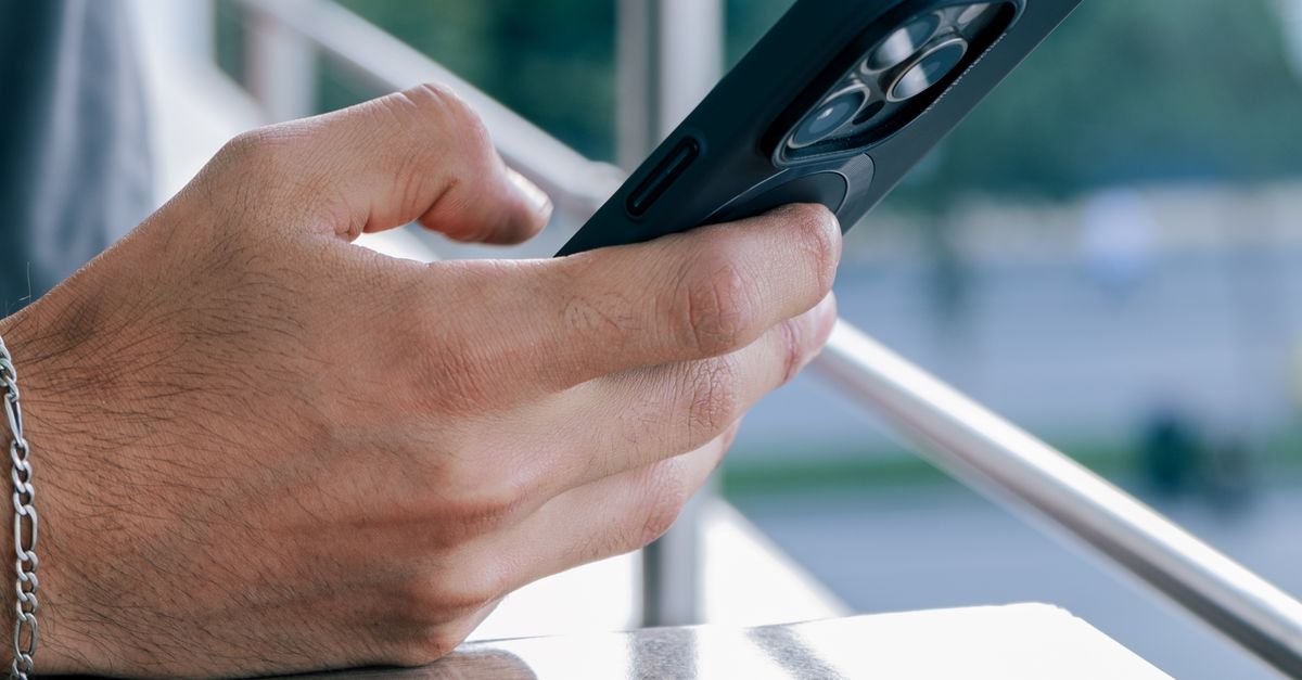 Close-Up of Hand Holding Smartphone Outdoors · Free Stock Photo