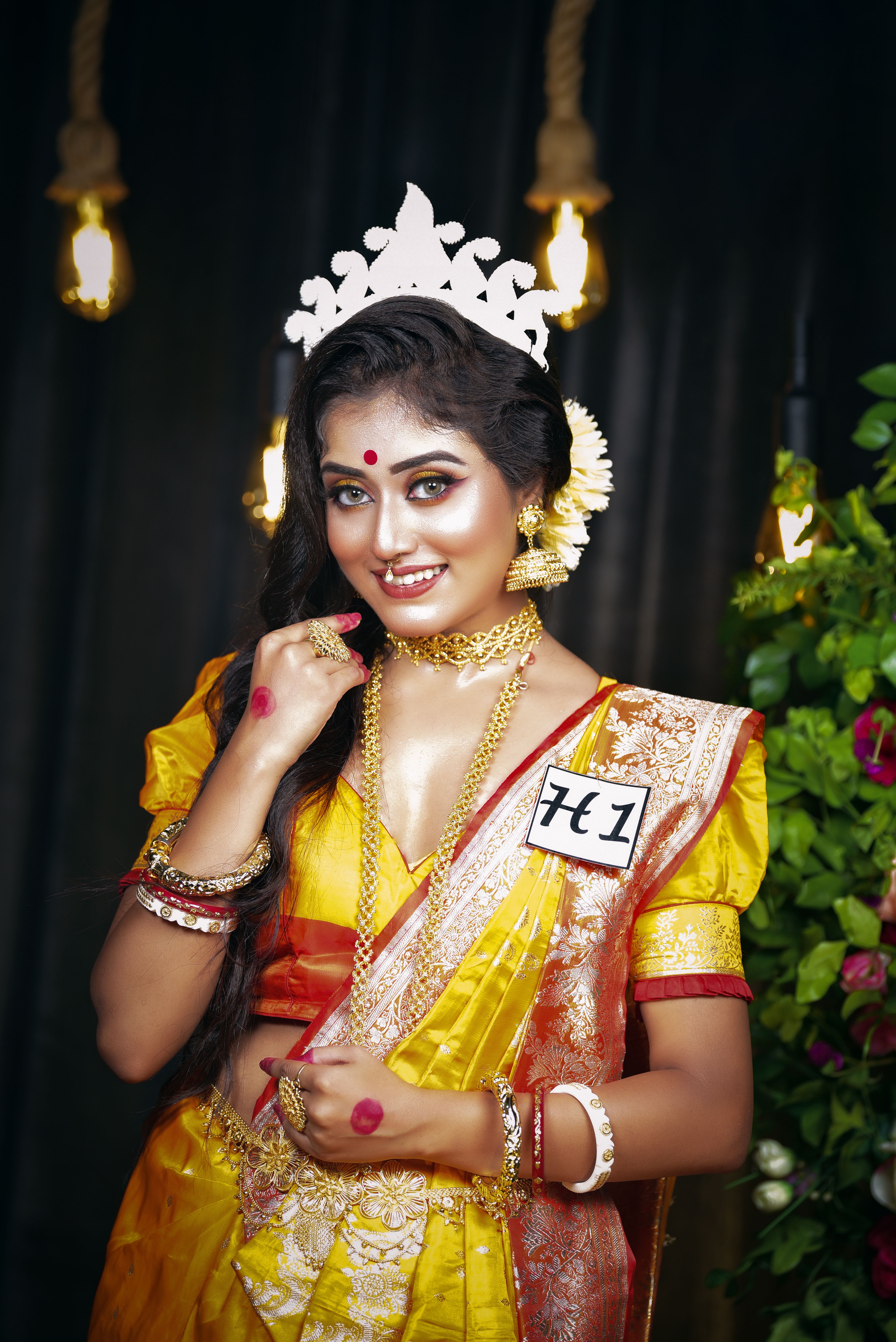 Portrait of a smiling woman in traditional Indian attire and jewelry, exuding elegance.