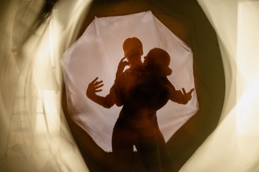 Abstract silhouette of dancers captured with blur effect, conveying movement and emotion.