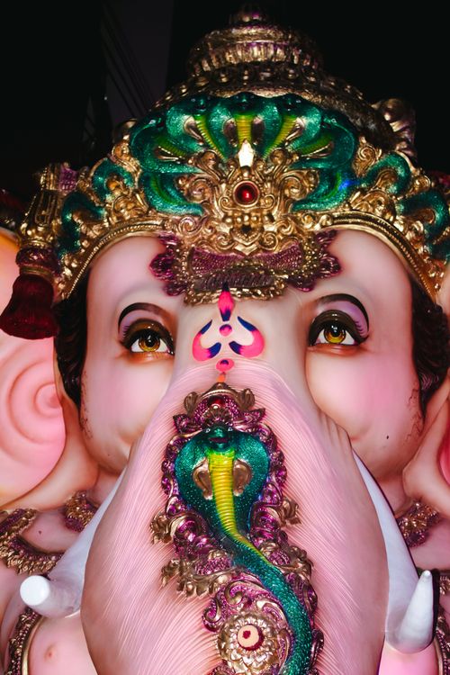 Free Vibrant close-up of a Ganesh idol with elaborate decorations, showcasing traditional art. Stock Photo