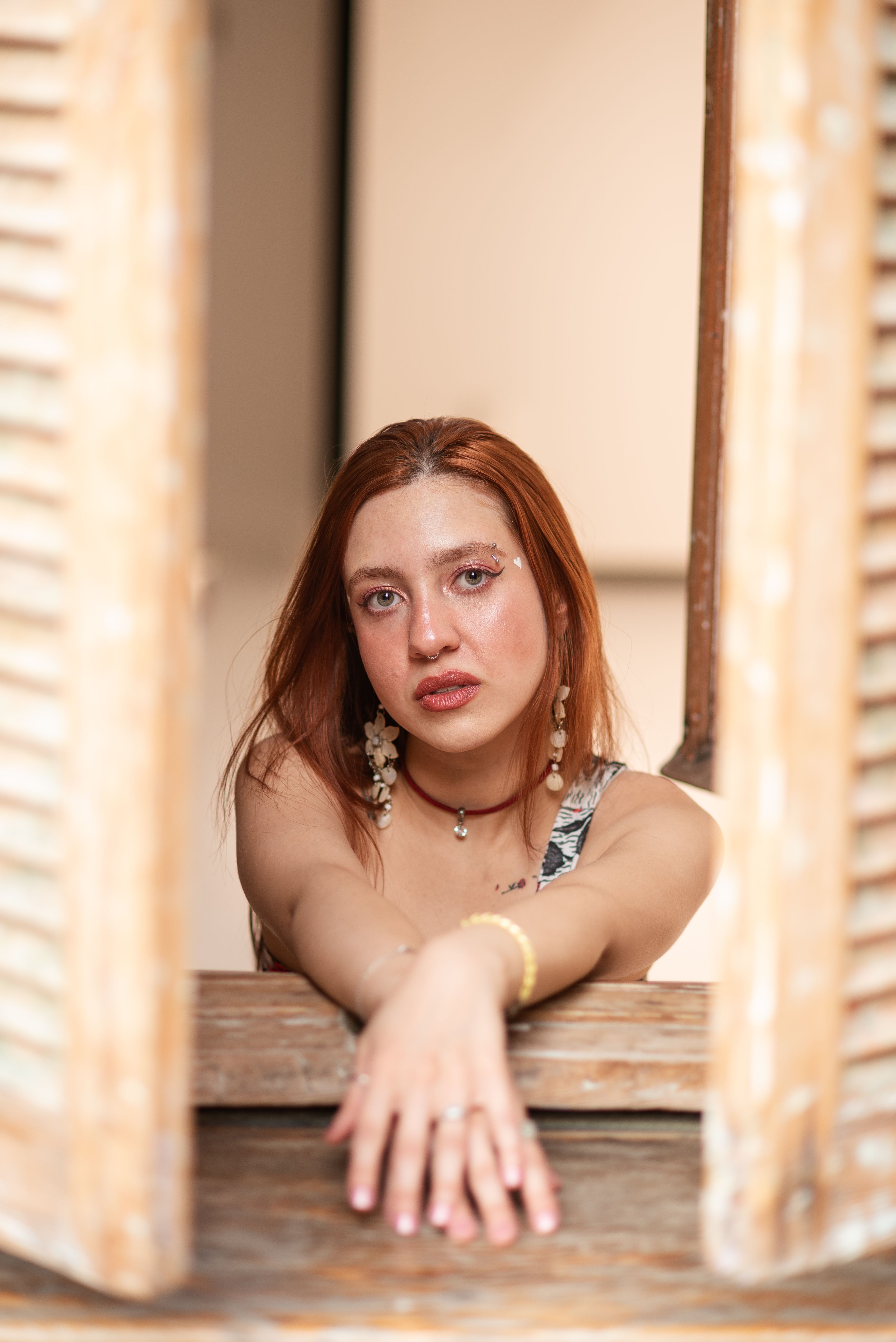 Portrait of a Young Woman Reaching Through Window · Free Stock Photo