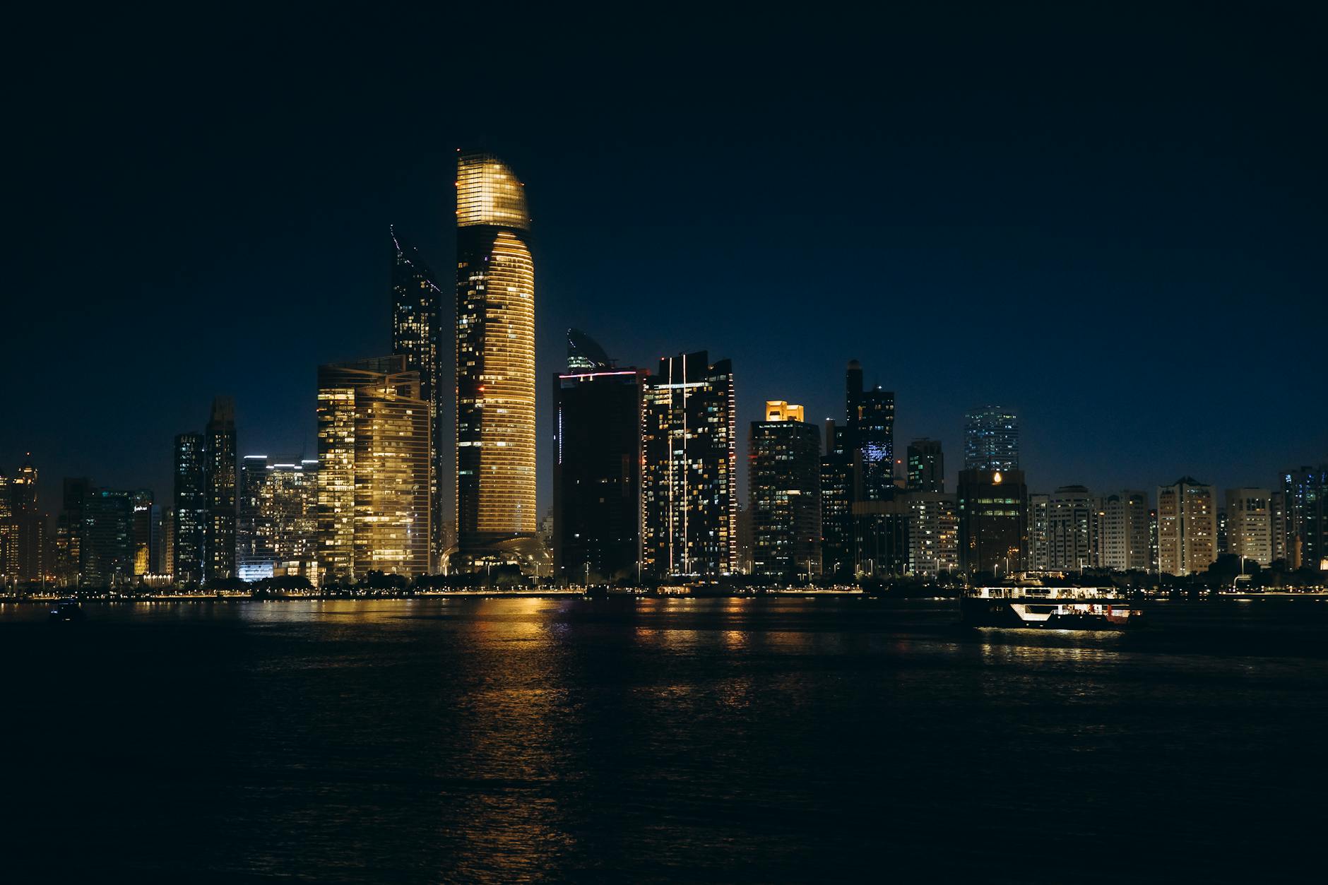 Explore Abu Dhabi's glittering skyline at night, showcasing modern architecture and vibrant city lights.
