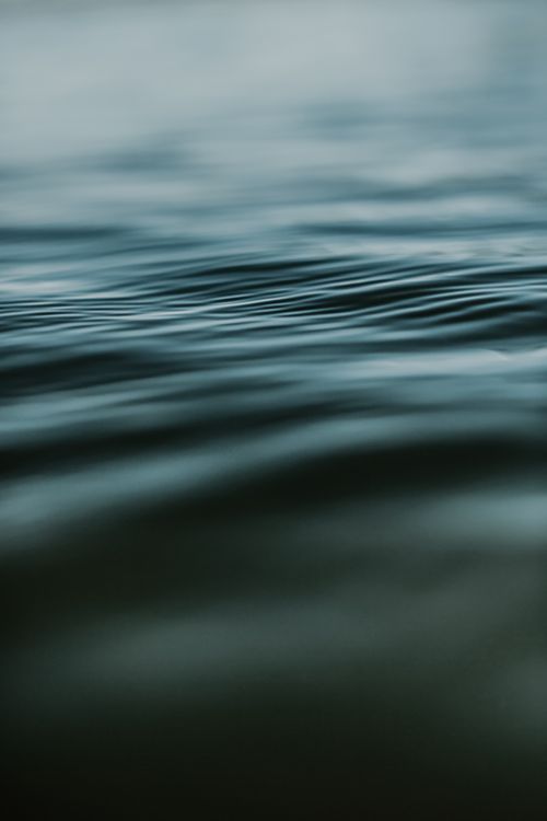 Free Close-up of gentle ripples on a calm water surface, perfect for tranquil background use. Stock Photo