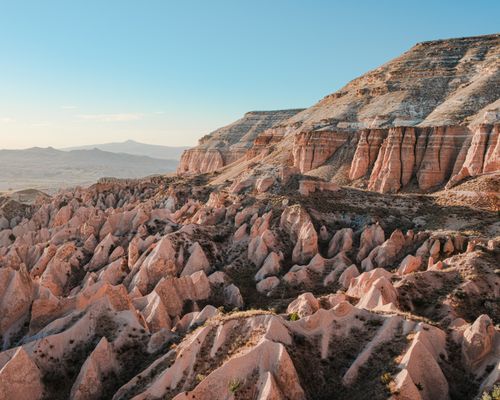 Free A breathtaking view of Cappadocia's distinctive rock formations under a clear blue sky. Stock Photo