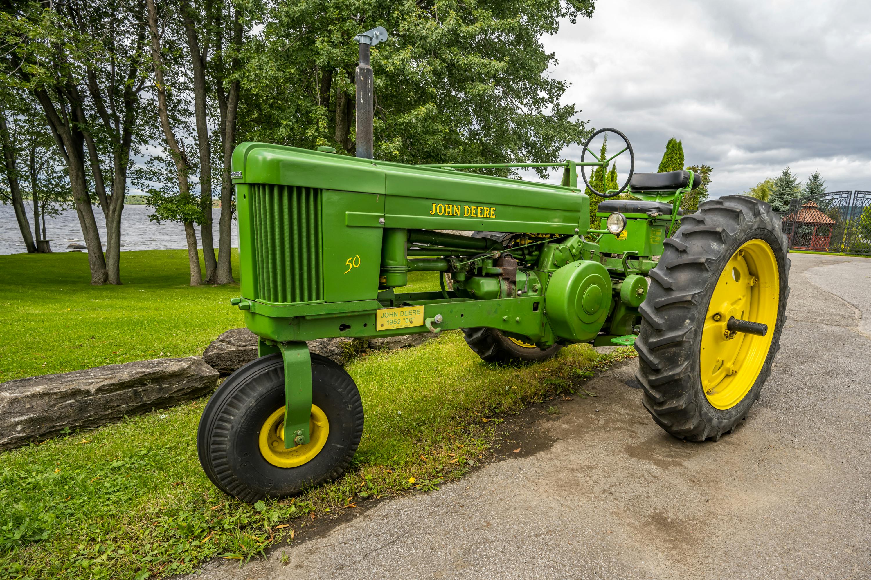 Vintage John Deere Tractor by Lakeside in Summer