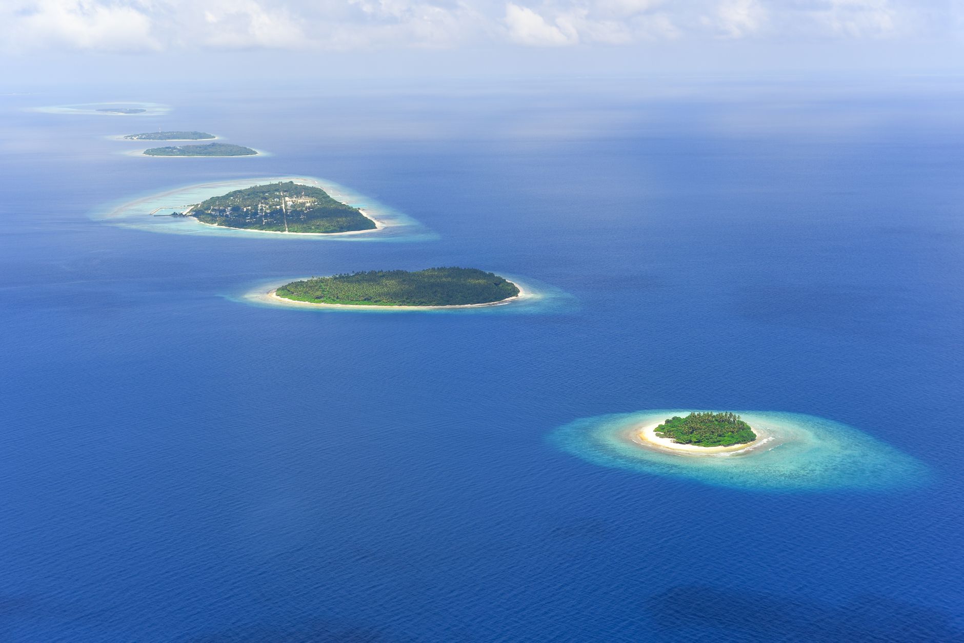 Discover the stunning aerial view of lush tropical islands surrounded by azure ocean waters.