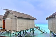 Serene overwater bungalows with turquoise ocean in a tropical paradise setting.