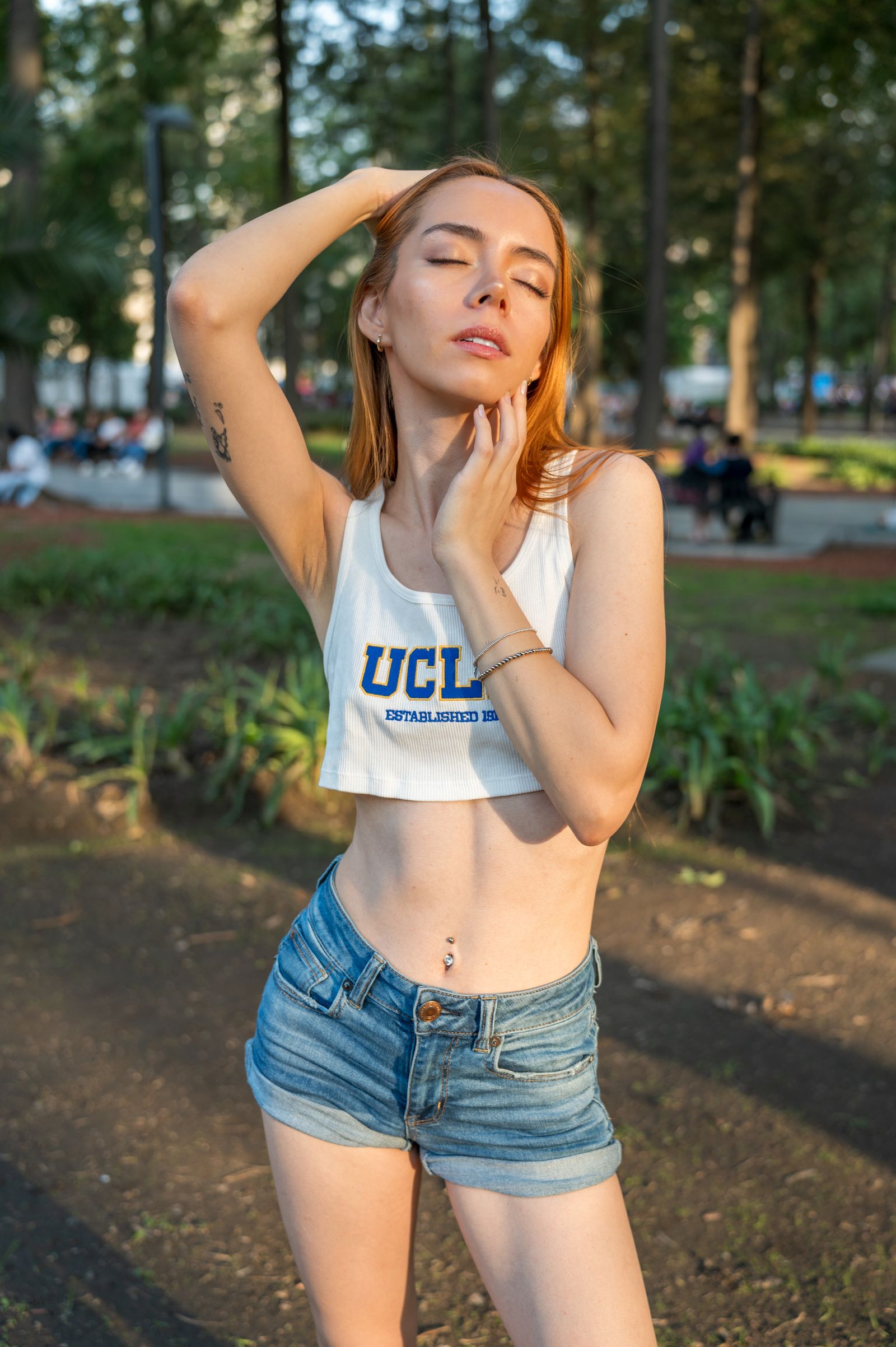 Stylish Woman in Urban Park Setting at Sunset · Free Stock Photo