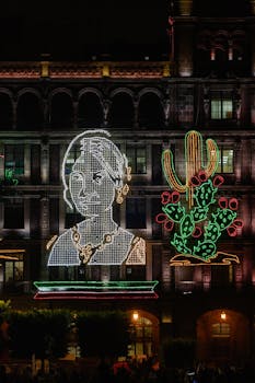 LED display of a woman and cactus with Mexican flag colors at night in Mexico City.