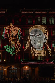 Illuminated facade in Mexico City's Zocalo celebrating Independence Day at night.