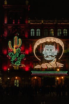 Colorful LED lights on a historic building in Mexico City, celebrating Mexican Independence Day.