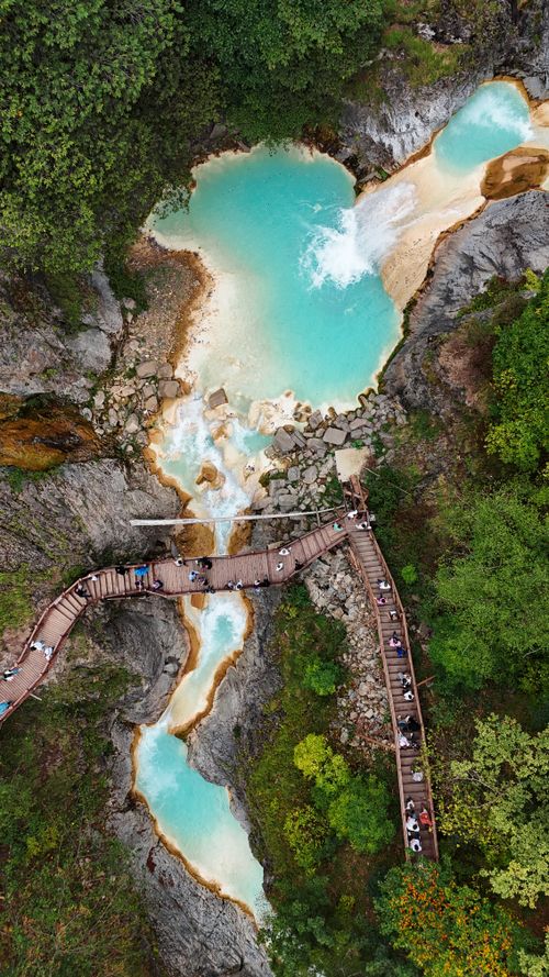 Free Stunning aerial photo of turquoise pools and wooden walkway in lush green nature. Stock Photo