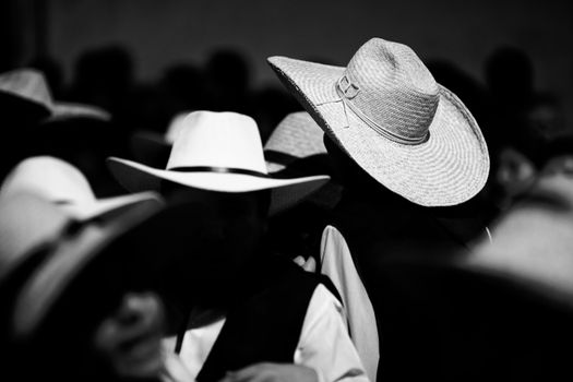 Artistic shot of a crowd in Arequipa, Peru, highlighting traditional hats.