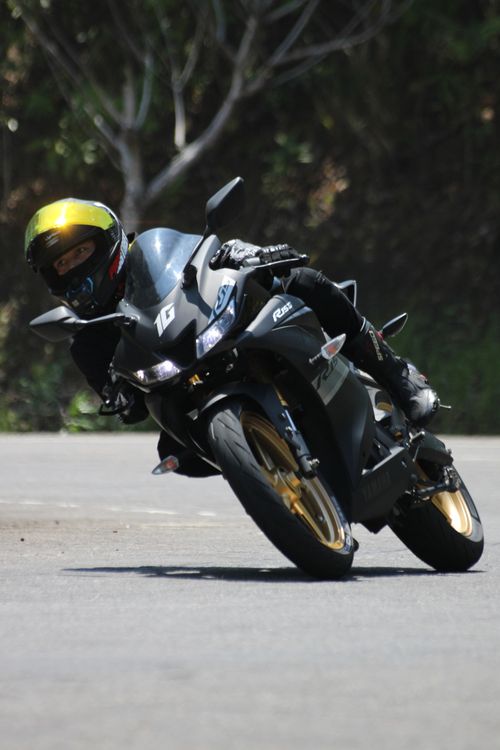 Free Exciting shot of a motorcyclist leaning into a sharp turn on a road. Adrenaline and speed captured. Stock Photo