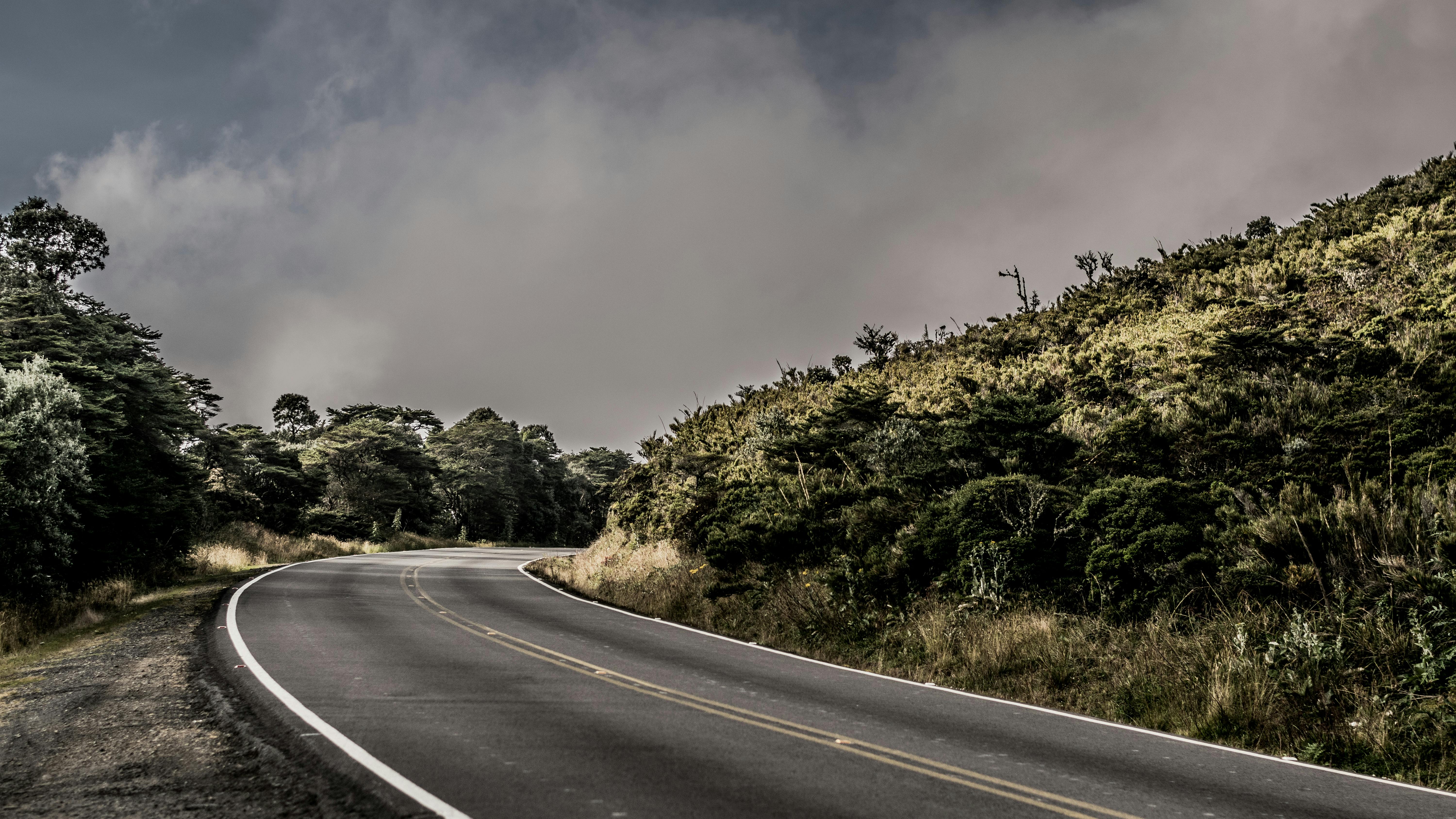 Winding road through lush greenery in Cartago, Costa Rica under a cloudy sky. - Cartago