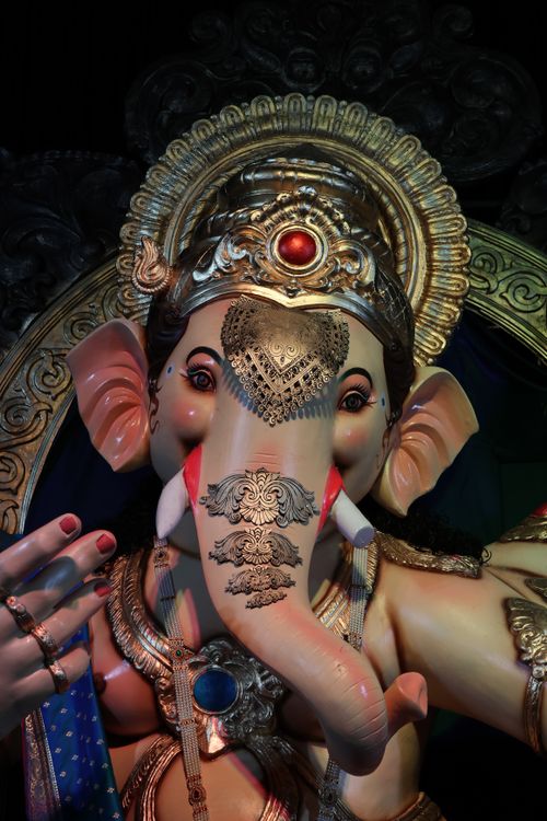 Free Detailed close-up of a traditional Lord Ganesha sculpture with ornate jewelry. Stock Photo