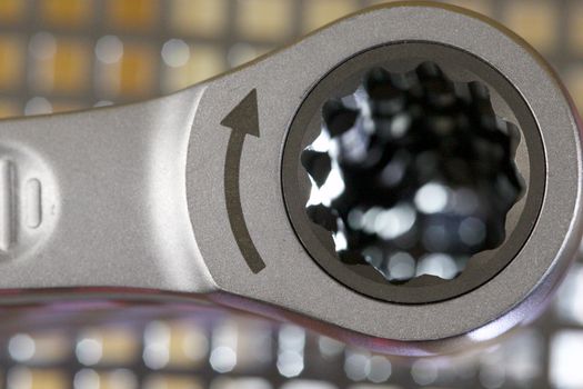 Detailed macro shot of a shiny metallic wrench head with textured grip.