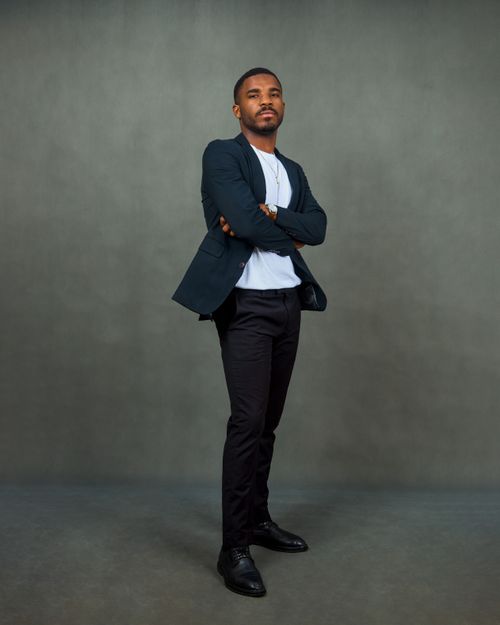 Free Portrait of a confident young man posing with arms crossed in formal business attire. Stock Photo