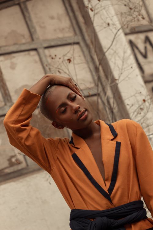 Free Stylish woman posing outdoors in fashionable attire, captured in a warm and moody setting in Rio de Janeiro. Stock Photo