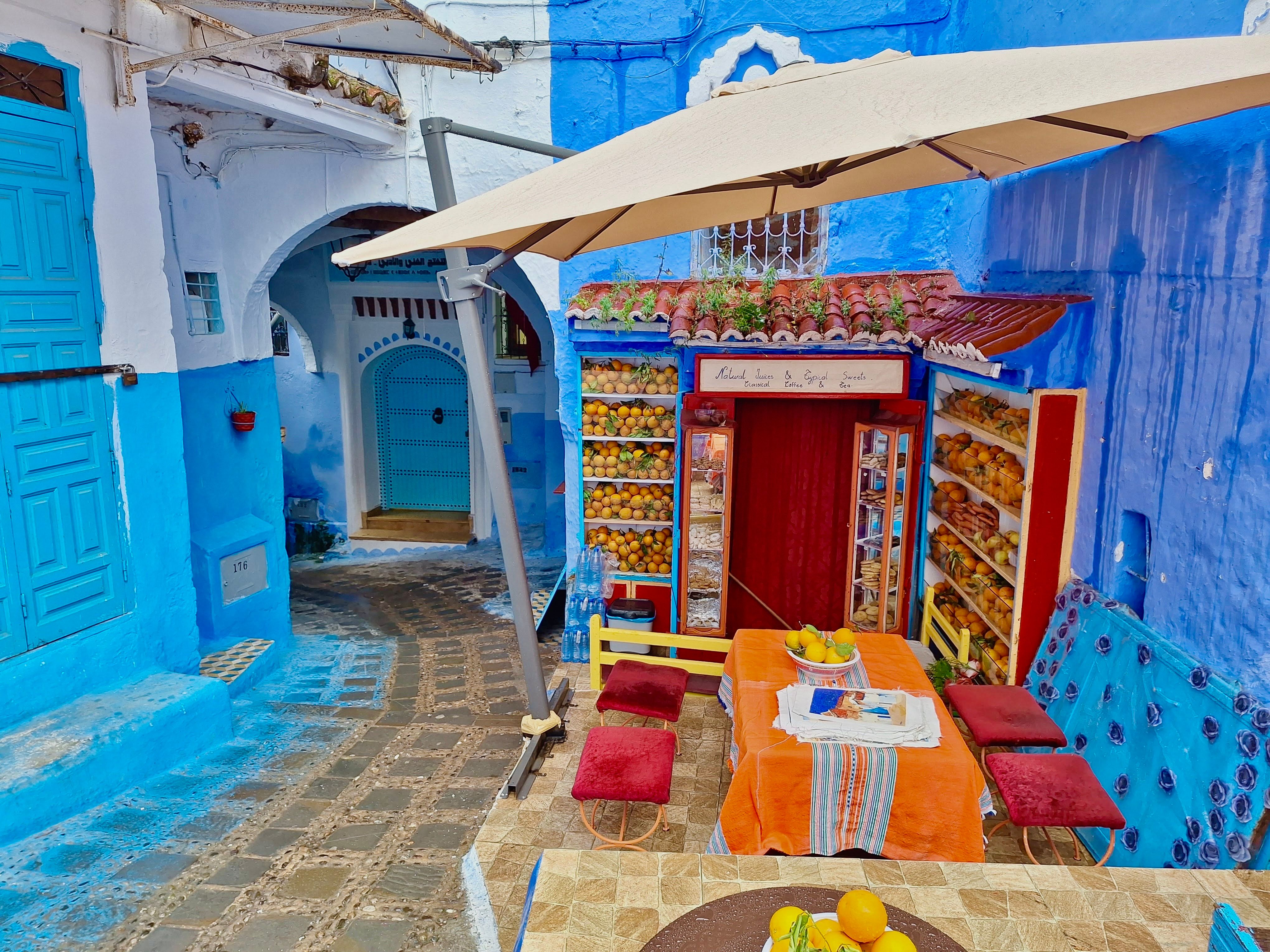 Vibrant outdoor cafe in the blue city of Chefchaouen, Morocco.