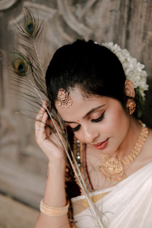Free Portrait of a South Asian woman in traditional dress with peacock feather accessory. Stock Photo
