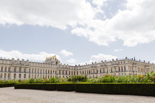 Free Stunning view of the Palace of Versailles with lush gardens under a bright sky. Stock Photo