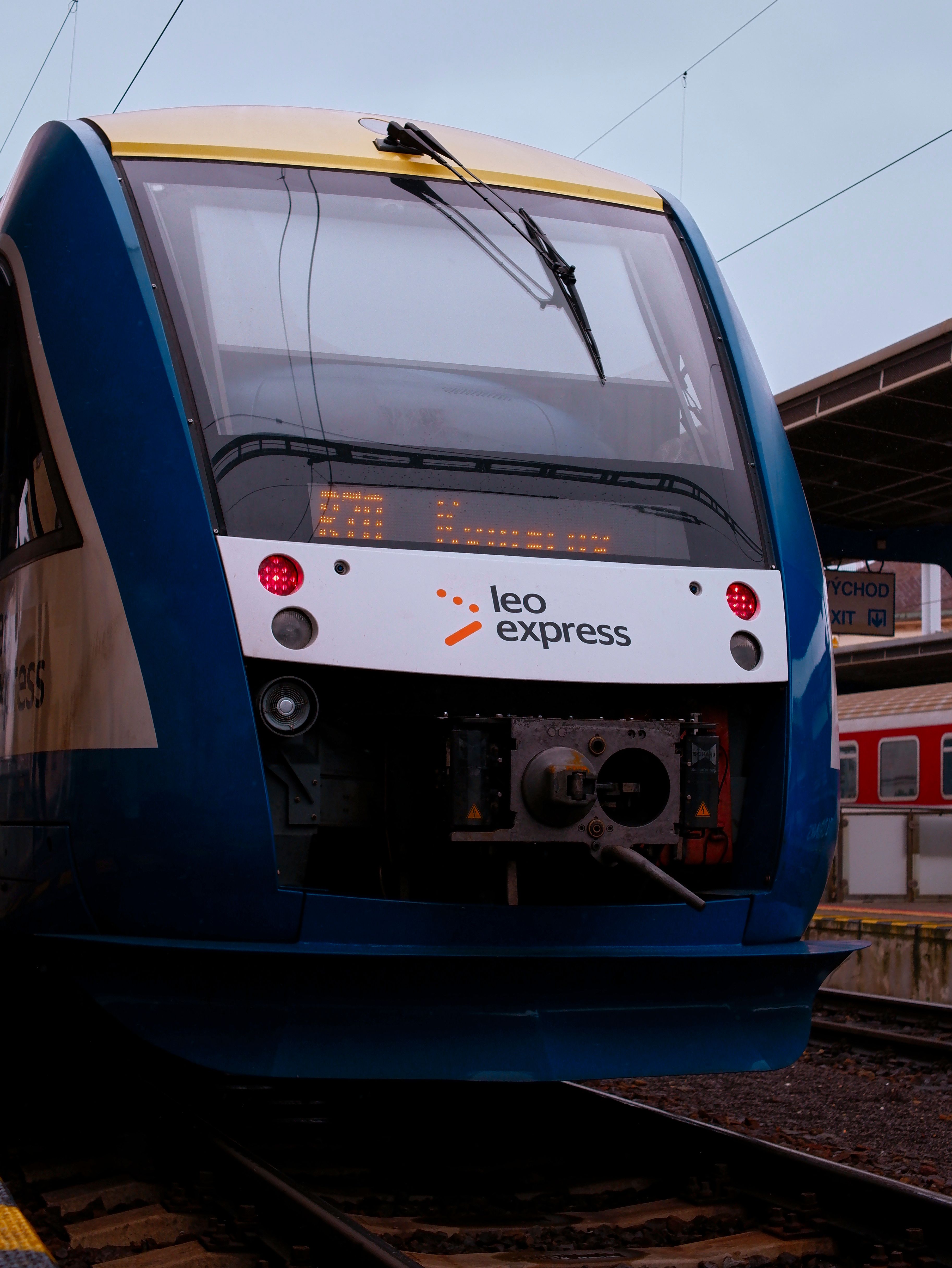 Close-up of a Leo Express train at a railway station platform, showcasing modern design.