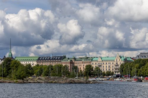 Free Urban landscape of Helsinki with historic buildings along the waterfront under a cloudy sky. Stock Photo