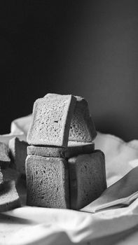 Black and white artistic shot of artisan bread slices stacked creatively.