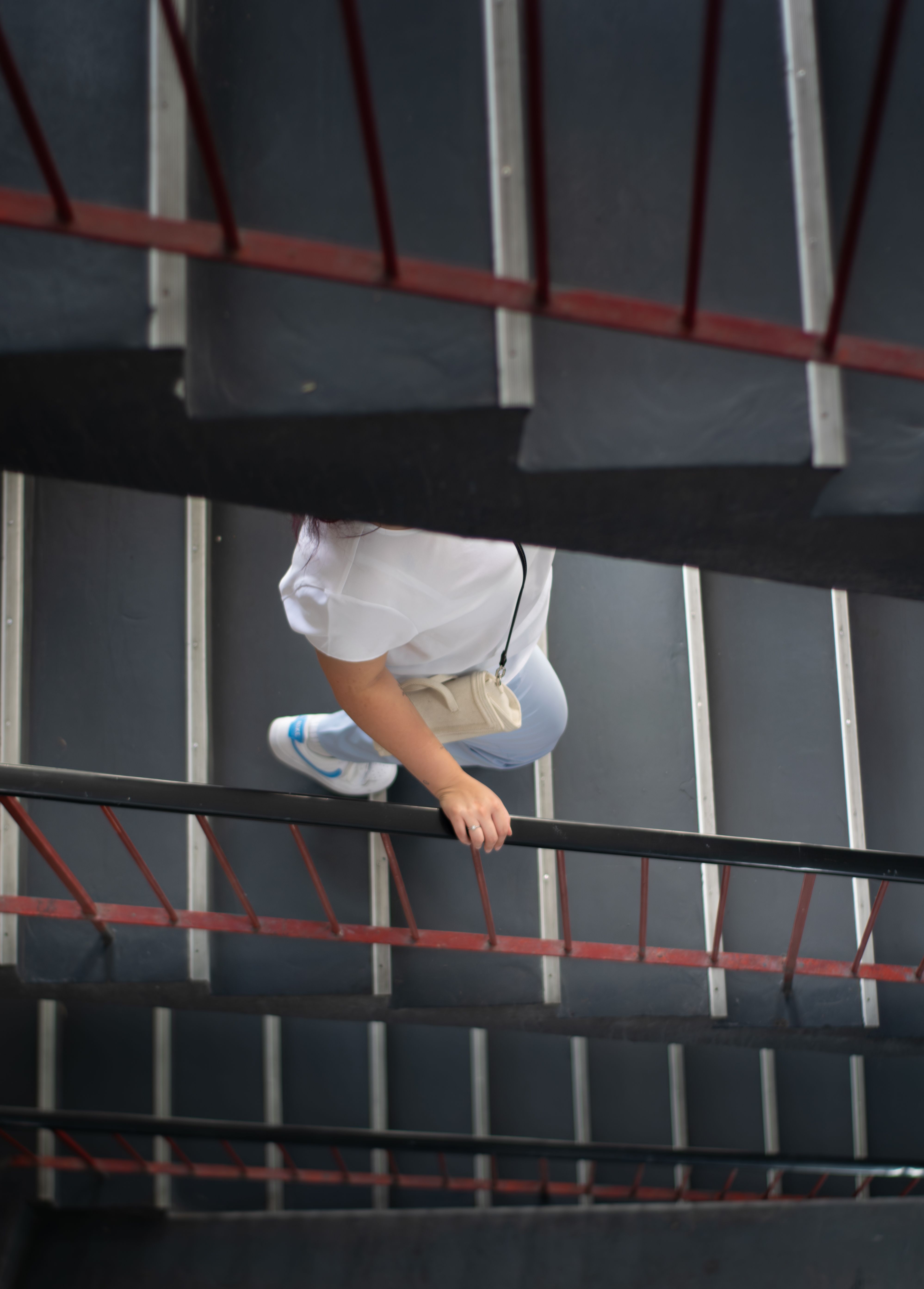 Woman Ascending Red-Railed Staircase in Bremen · Free Stock Photo