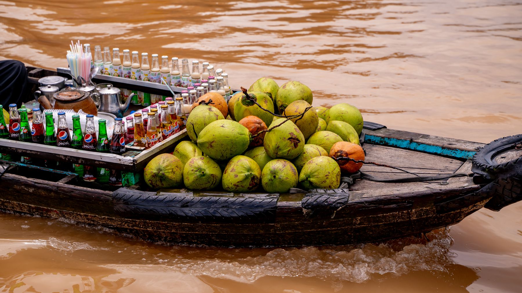 A boat selling coconuts and drinks at the floating market in Cần Thơ, Vietnam.