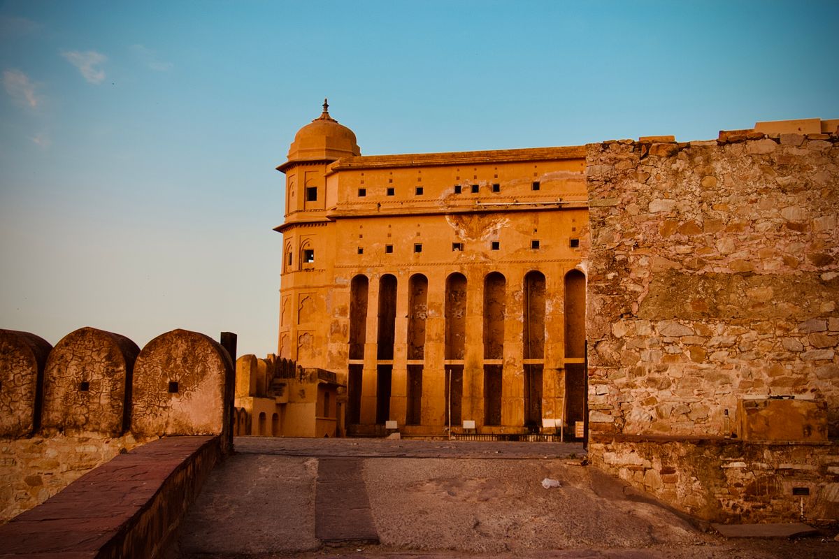 Jaipur's Amber Fort at sunset — carved marble and mirror mosaic palaces approached by elephant or jeep.