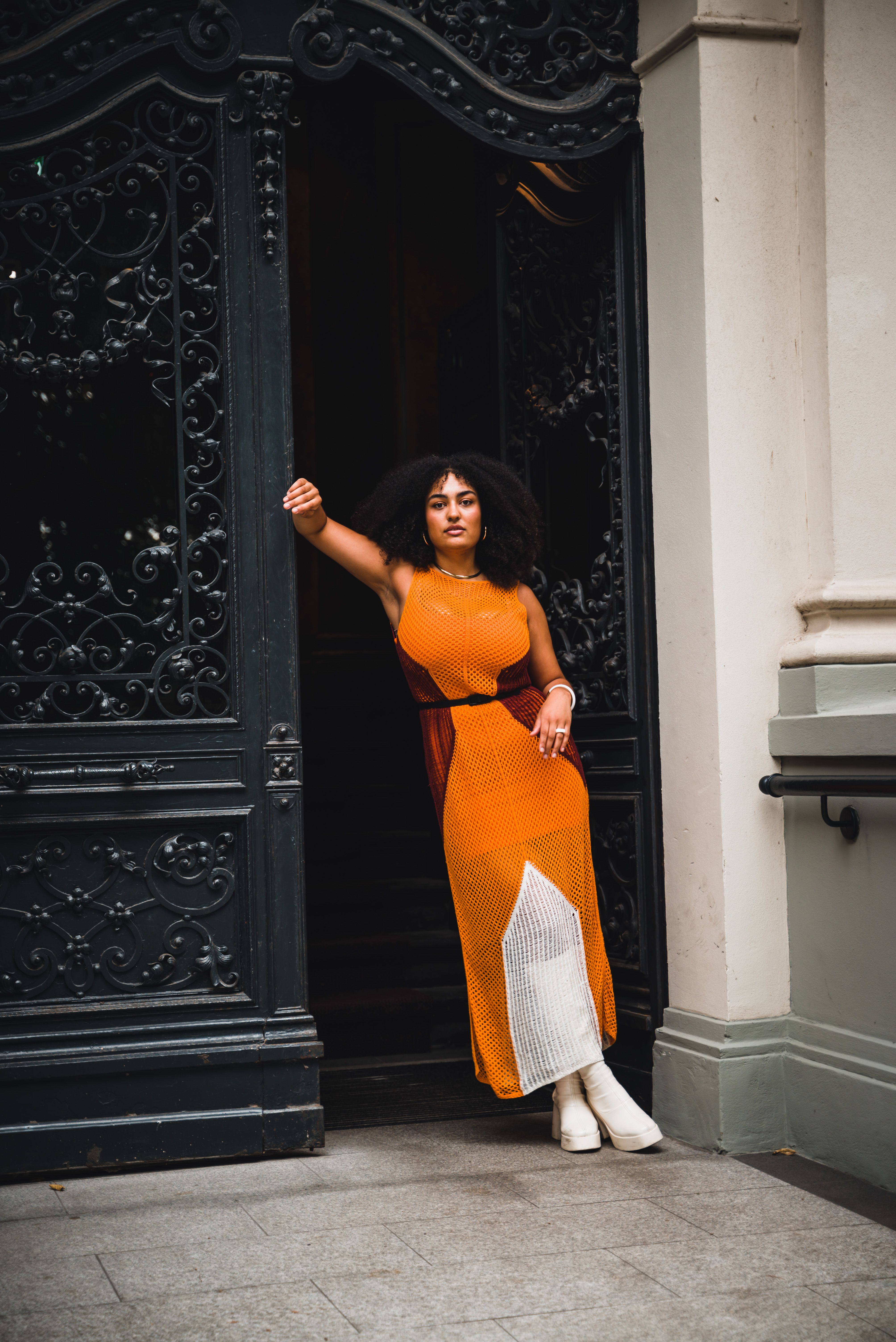 Stylish Woman Posing in Front of Ornate Doorway · Free Stock Photo