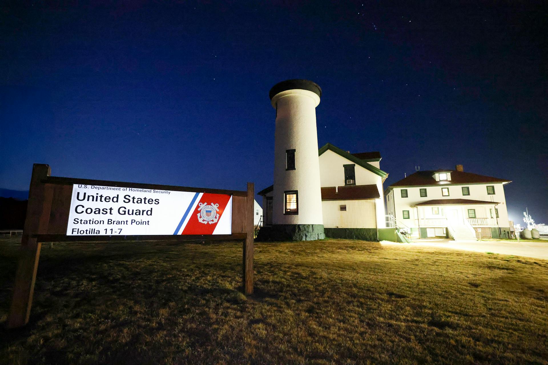 Night view of Brant Point Lighthouse and Coast Guard Station in Nantucket, MA.