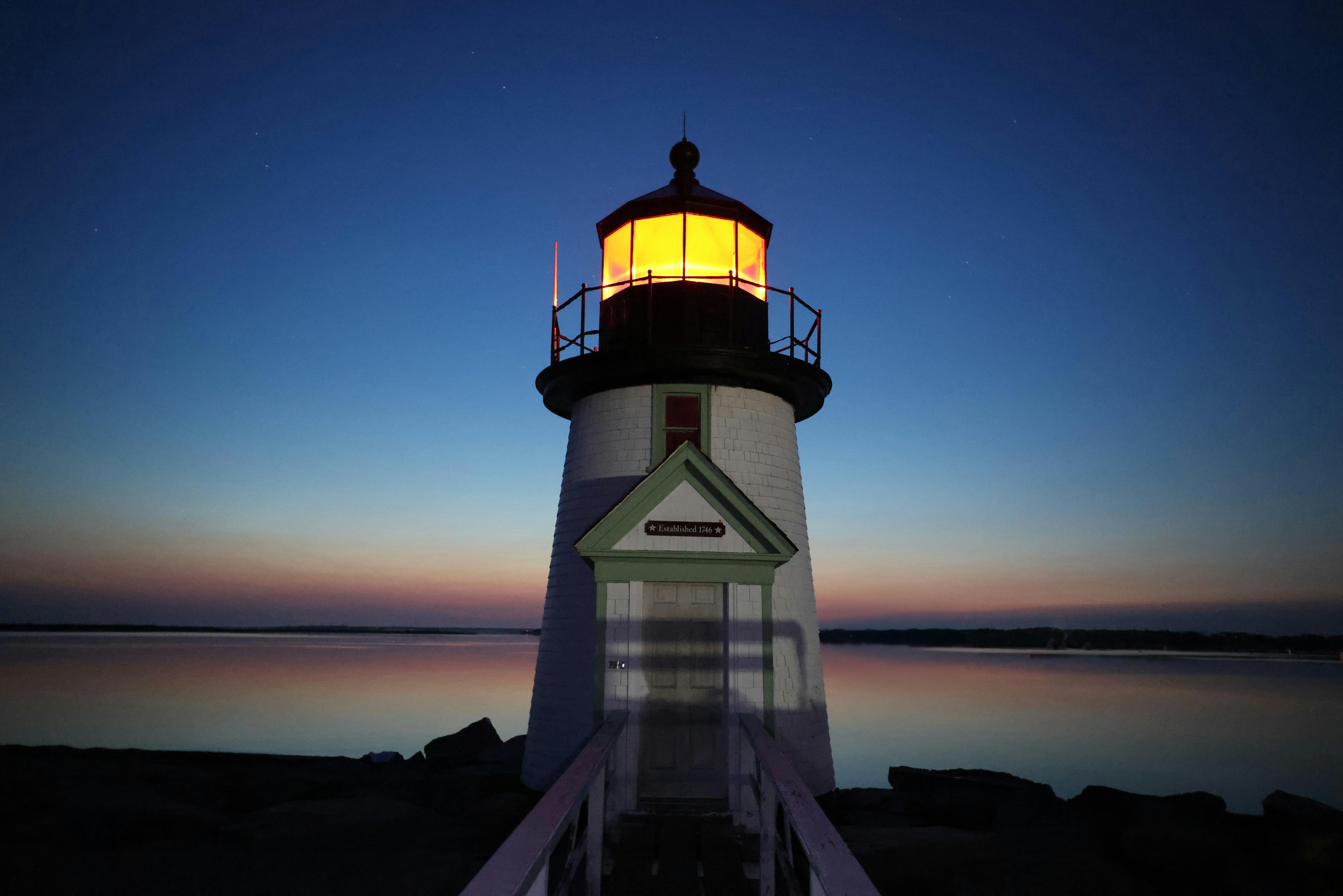 A stunning view of Brant Point Lighthouse at twilight, capturing the serene beauty of Nantucket's coastline.