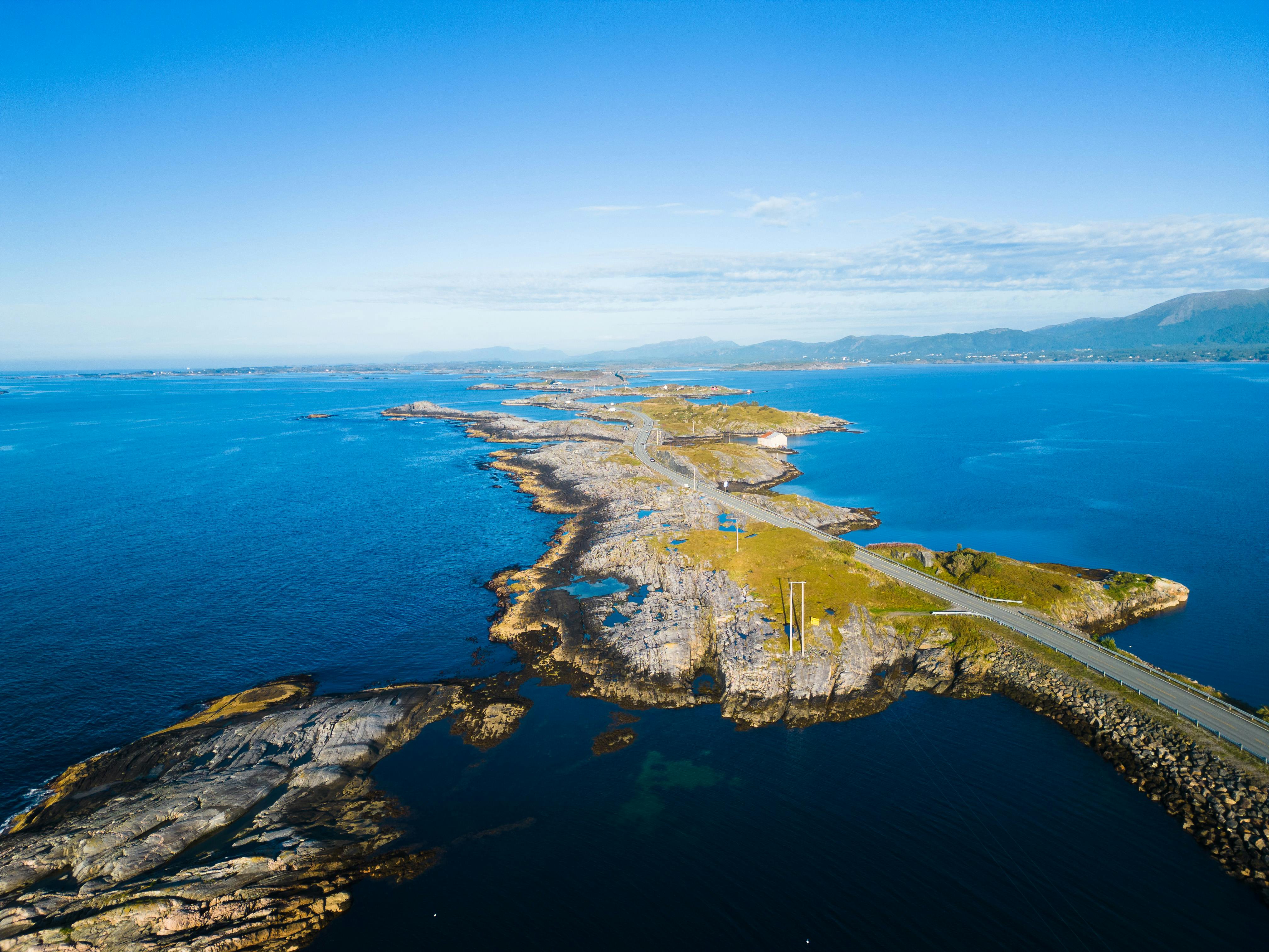 Aerial view of the stunning Atlantic Road in Kristiansund, Norway, surrounded by blue ocean.