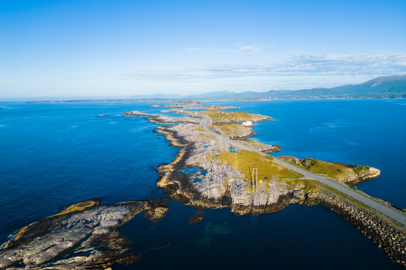 Aerial view of the stunning Atlantic Road in Kristiansund, Norway, surrounded by blue ocean.