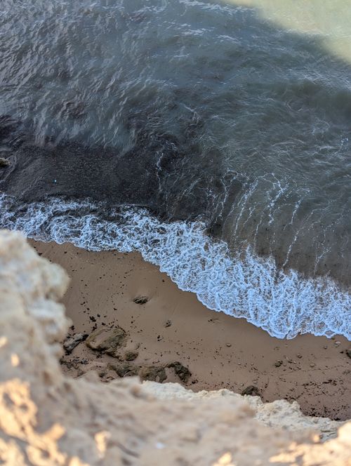 Free A scenic aerial shot of a sandy beach in Spain, with gentle waves lapping against the shore. Stock Photo
