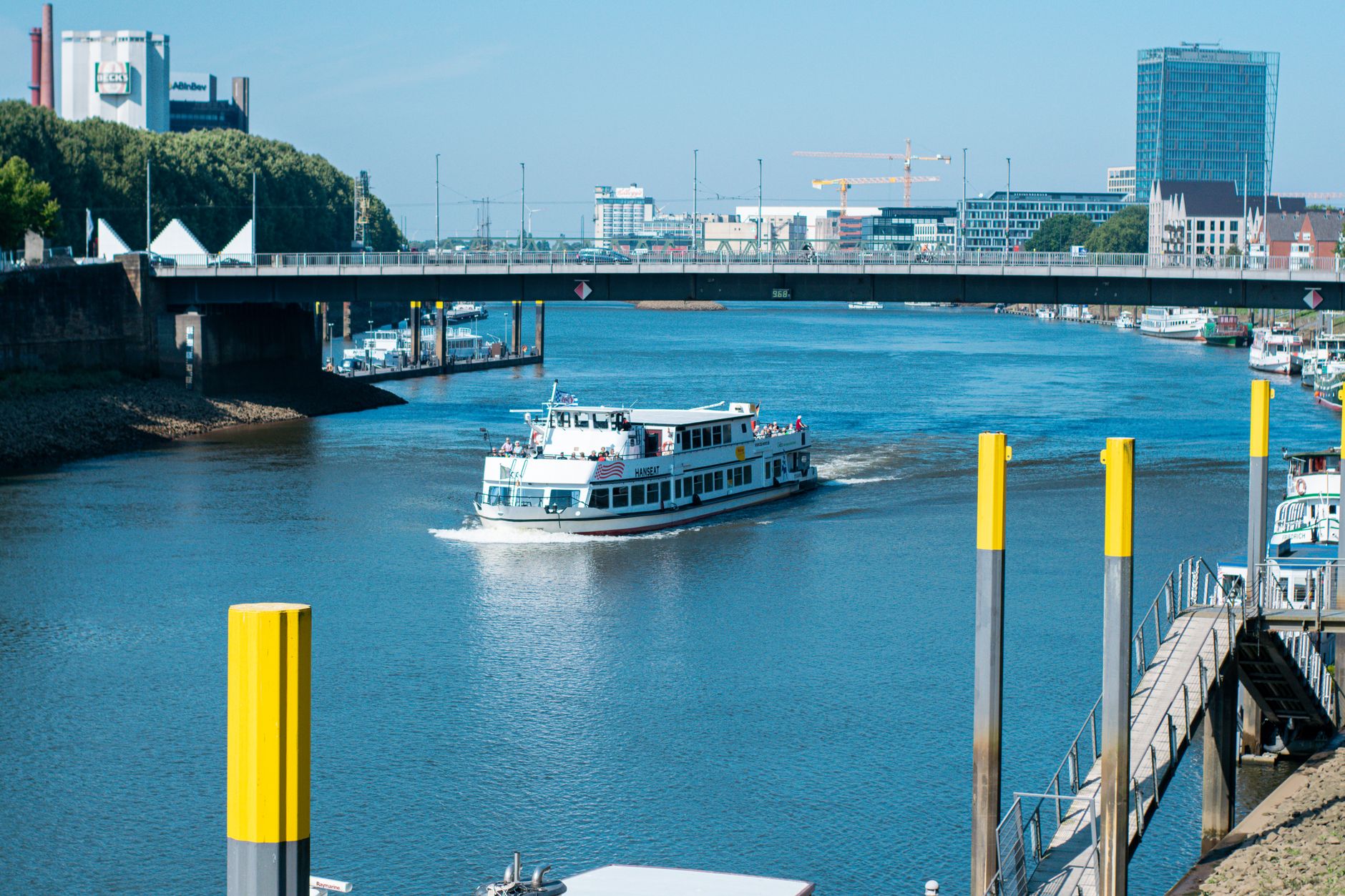 Scenic view of a cruise ship sailing on the Weser River in Bremen, Germany.