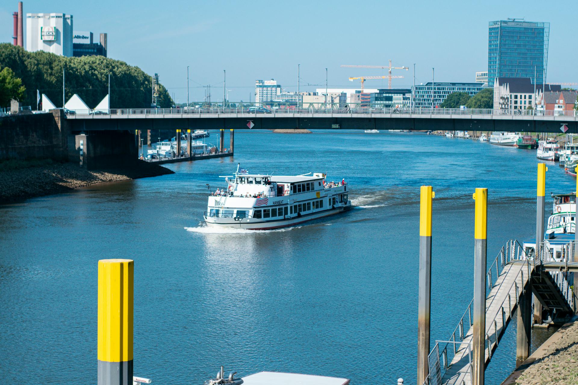 Scenic view of a cruise ship sailing on the Weser River in Bremen, Germany.