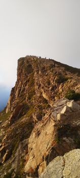 Stunning coastal cliff view with hikers at Cabo da Roca in Sintra, Portugal.
