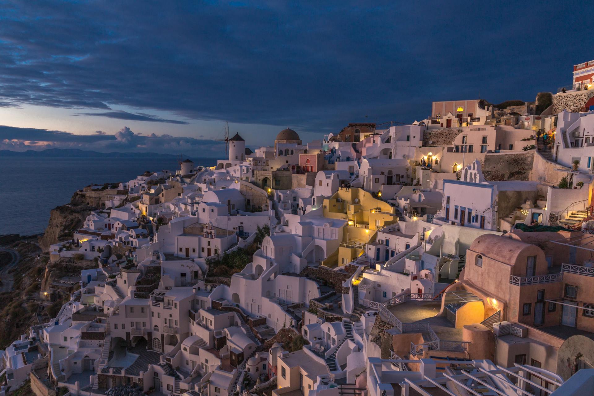 Breathtaking twilight view of Fira, Santorini showcasing iconic Greek architecture.