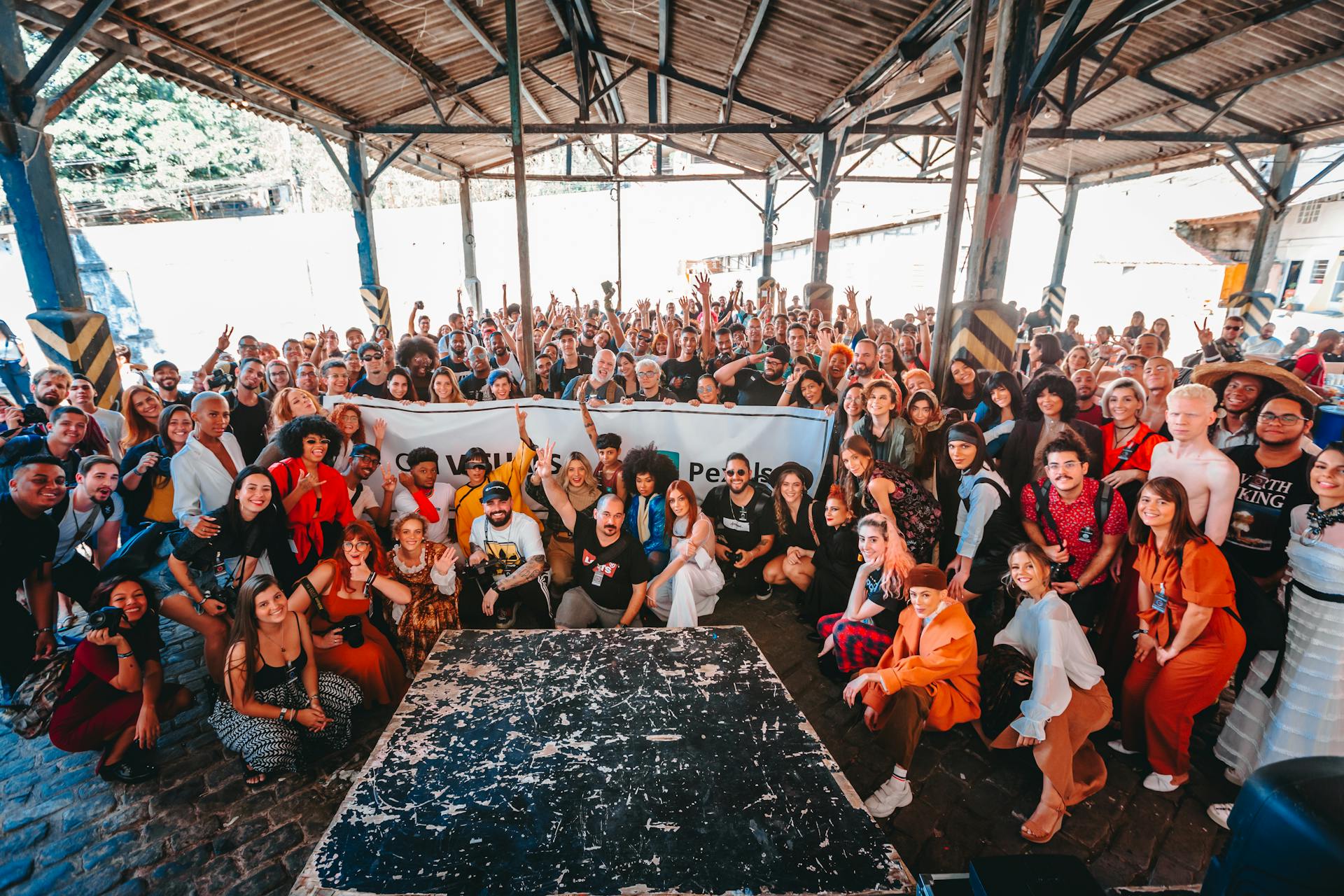 Vibrant group photo in a warehouse in Rio de Janeiro showcasing diversity and togetherness.