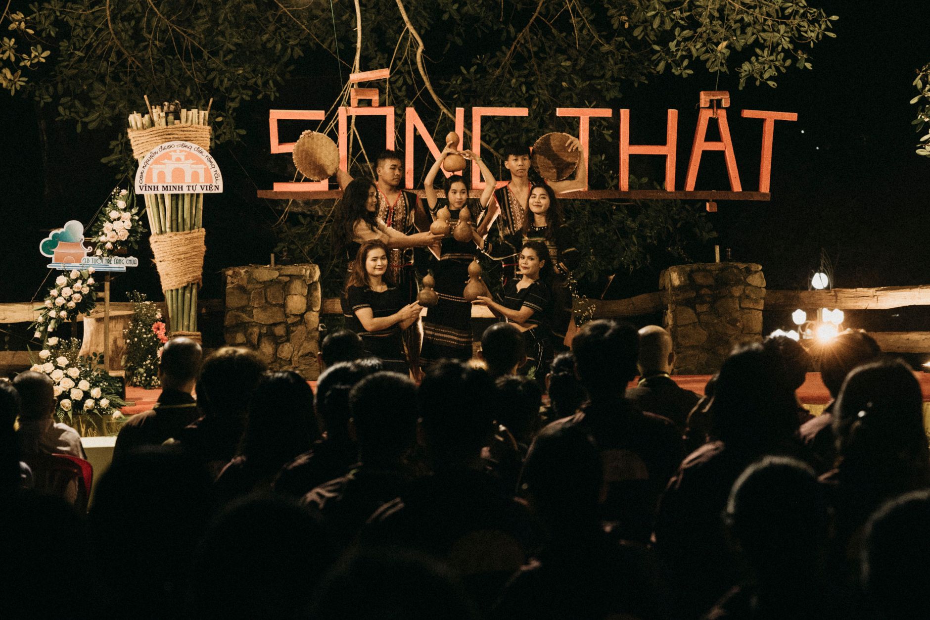 People gather for an evening cultural performance with traditional music and dance.